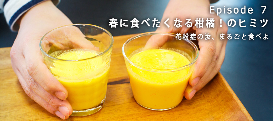ミカンの皮とヨーグルトのドリンクを手に持つ