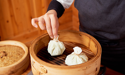 蒸し器に茶巾を入れる様子